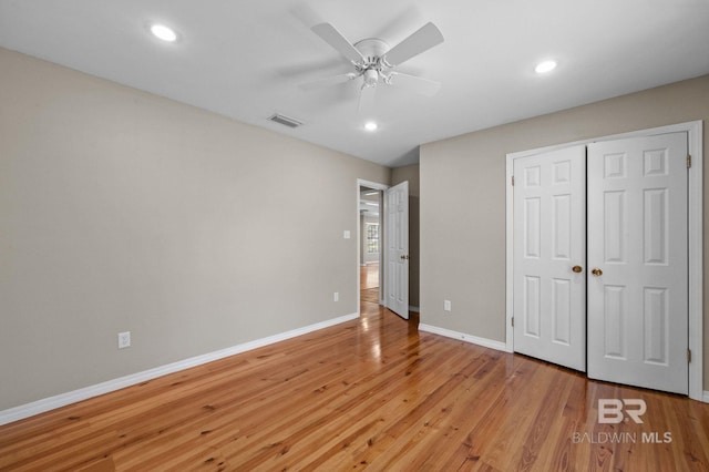 unfurnished bedroom with baseboards, visible vents, light wood-style floors, a closet, and recessed lighting