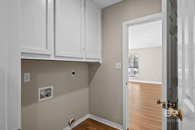 laundry area with hookup for a washing machine, cabinet space, hookup for an electric dryer, wood finished floors, and baseboards