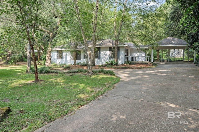 ranch-style house with driveway, a front lawn, and a carport