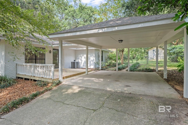 view of patio / terrace featuring a carport, central AC, and fence