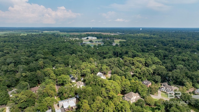 drone / aerial view with a wooded view