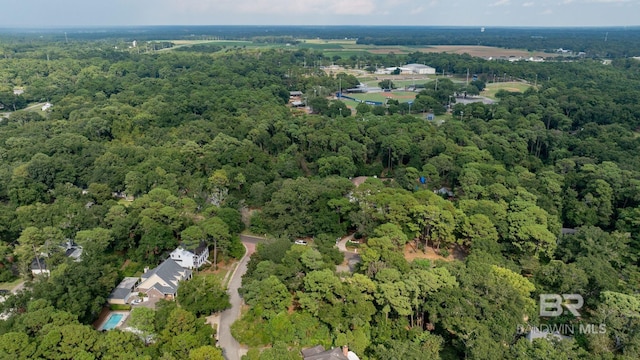 drone / aerial view featuring a wooded view