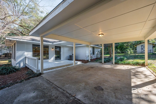 view of patio with central air condition unit and a carport