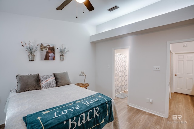 bedroom featuring ceiling fan, wood-type flooring, and ensuite bathroom