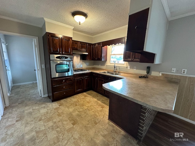 kitchen featuring appliances with stainless steel finishes, a textured ceiling, crown molding, sink, and kitchen peninsula