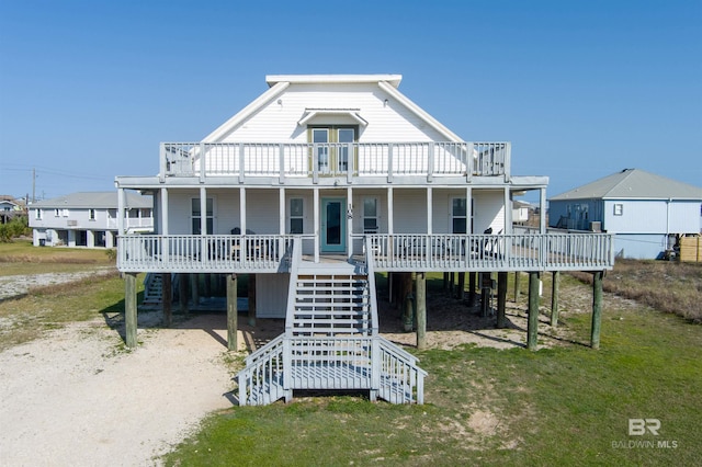 108 Ponchartrain Ct, Dauphin Island, AL 36528 - coastal home with stairway, a porch, and a front lawn