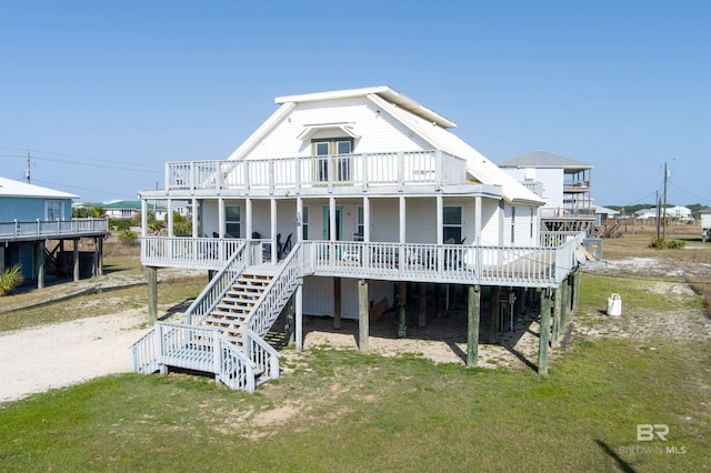 108 Ponchartrain Ct, Dauphin Island, AL 36528 - rear view of property with a lawn, stairs, and covered porch