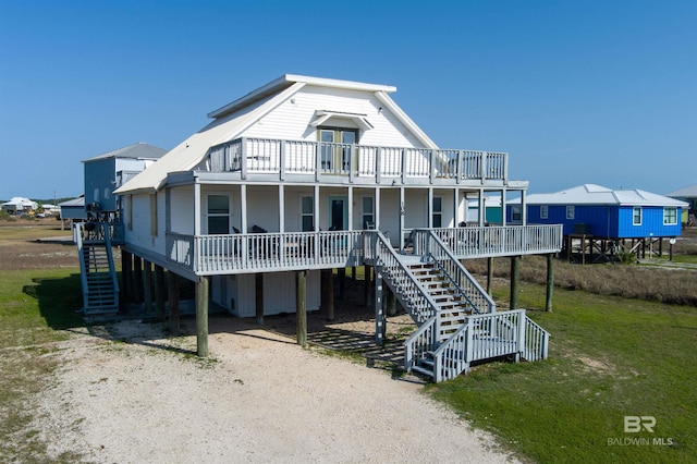 108 Ponchartrain Ct, Dauphin Island, AL 36528 - coastal home featuring stairway and a porch