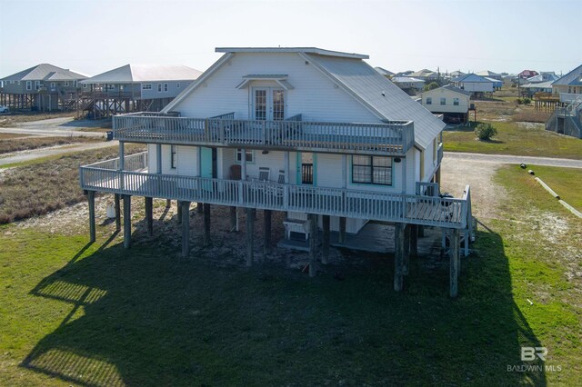 108 Ponchartrain Ct, Dauphin Island, AL 36528 - back of property featuring a deck, a lawn, and a residential view