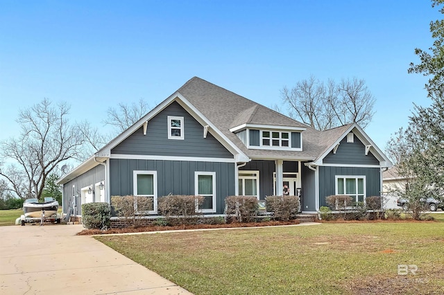 view of front of home featuring a front yard and a garage