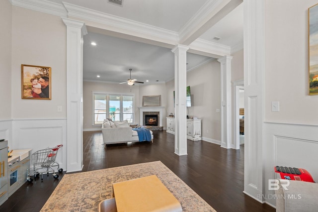 living room featuring crown molding, ceiling fan, and dark wood-type flooring