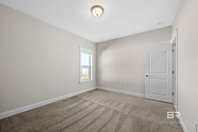 spare room with light colored carpet