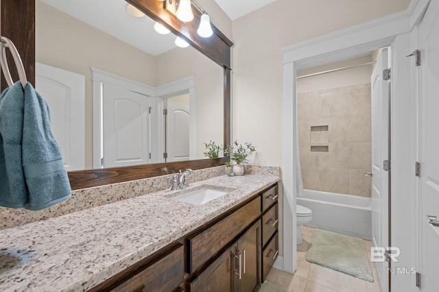 full bathroom featuring toilet, vanity, tile patterned floors, and tiled shower / bath