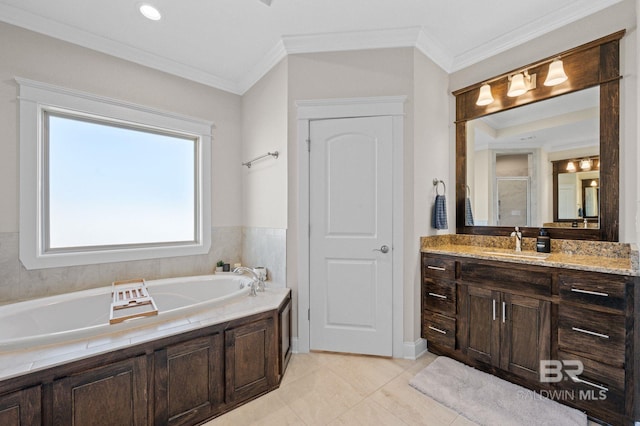 bathroom with tile patterned flooring, vanity, a tub to relax in, and ornamental molding