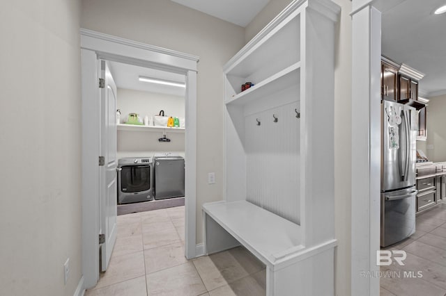 mudroom with separate washer and dryer and light tile patterned floors