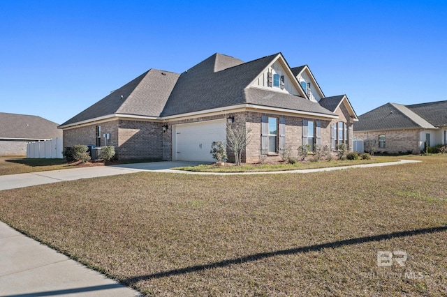 view of front of house featuring central AC, a garage, and a front lawn