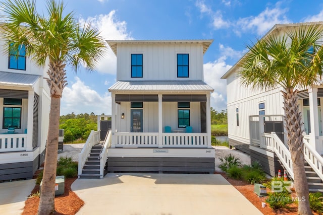 2457 Saltgrass Way Unit 8, Orange Beach, AL 36561 - view of front of house with board and batten siding, a porch, metal roof, and stairs