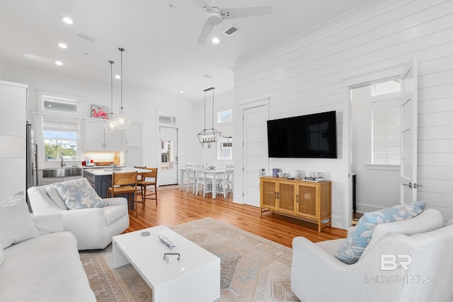 2457 Saltgrass Way Unit 8, Orange Beach, AL 36561 - living room with visible vents, ceiling fan, crown molding, recessed lighting, and light wood-style flooring