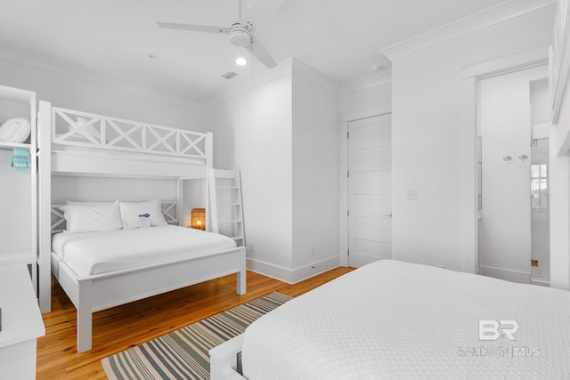 2457 Saltgrass Way Unit 8, Orange Beach, AL 36561 - bedroom featuring visible vents, baseboards, ceiling fan, crown molding, and wood finished floors
