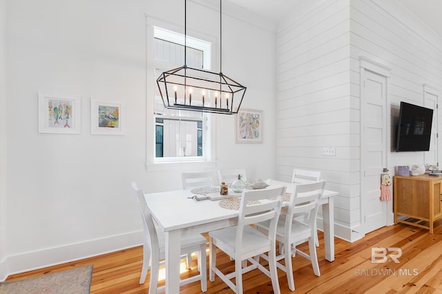 2457 Saltgrass Way Unit 8, Orange Beach, AL 36561 - dining area featuring baseboards, a chandelier, and light wood-style floors