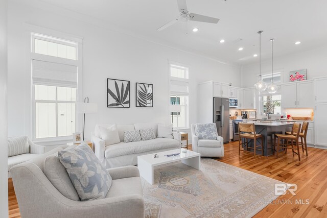 2457 Saltgrass Way Unit 8, Orange Beach, AL 36561 - living room featuring recessed lighting, light wood-style flooring, a high ceiling, and ceiling fan