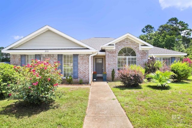 29153 Canterbury Rd, Daphne, AL 36526 - view of front of property with a front yard, brick siding, and a shingled roof