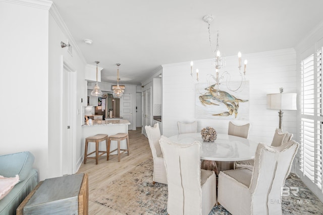 24900 Perdido Beach Blvd Unit 1001, Orange Beach, AL 36561 - dining room featuring an inviting chandelier, ornamental molding, and light hardwood / wood-style flooring