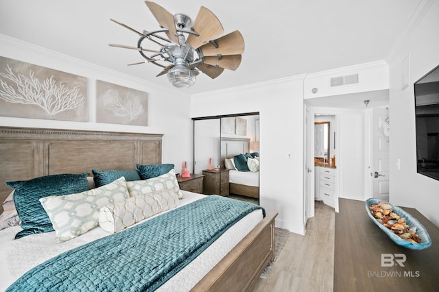 24900 Perdido Beach Blvd Unit 1001, Orange Beach, AL 36561 - bedroom featuring ceiling fan, light hardwood / wood-style floors, ornamental molding, and a closet