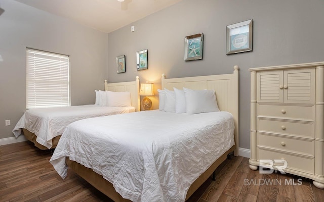 bedroom with wood finished floors and baseboards