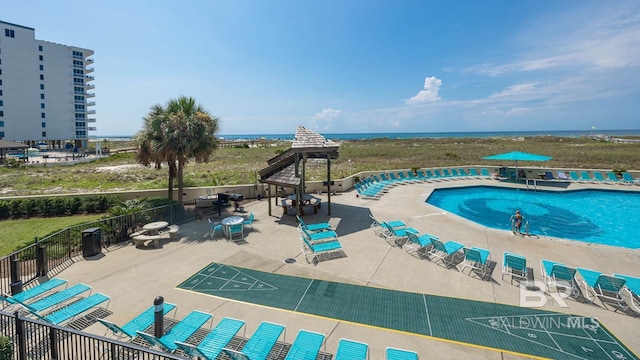 community pool featuring shuffleboard and fence