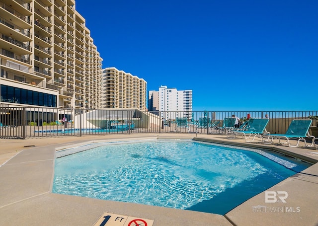 community pool featuring fence