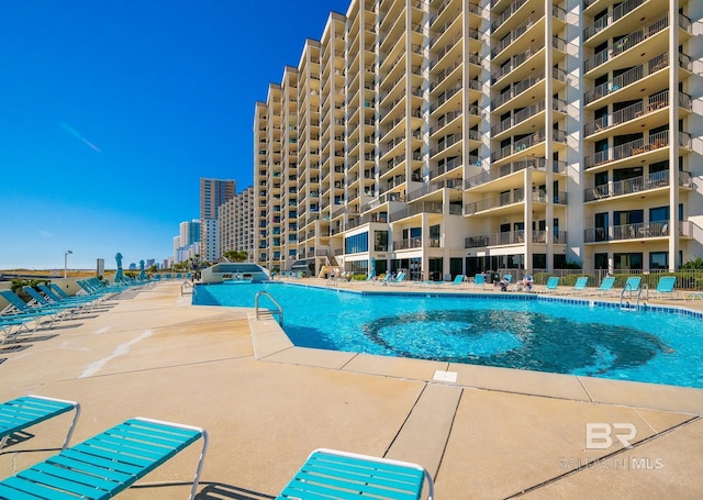 community pool with a patio area