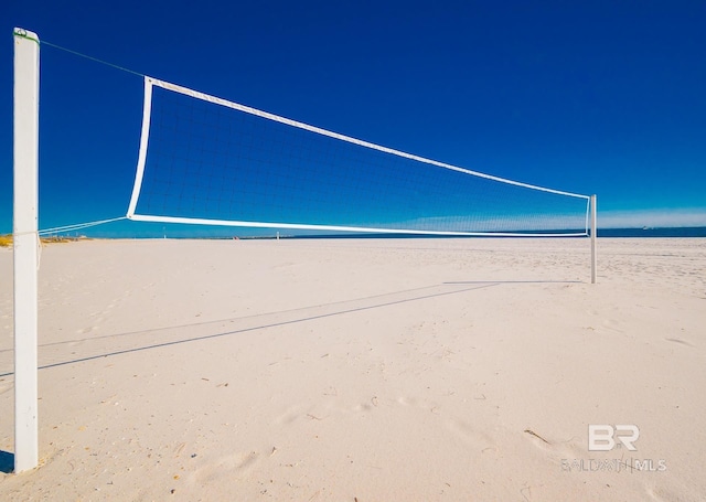 view of community with volleyball court and a water view
