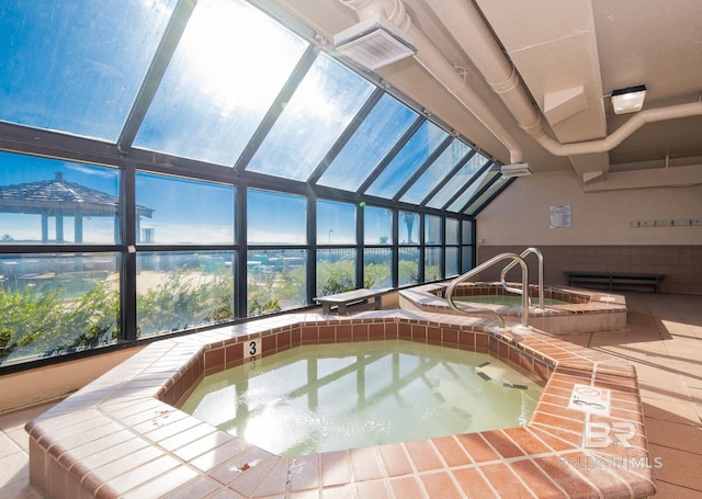 view of pool with an in-ground hot tub