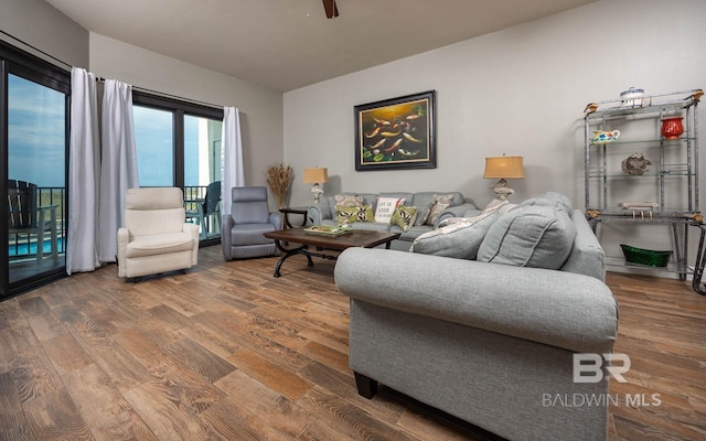 living room with wood finished floors and a ceiling fan