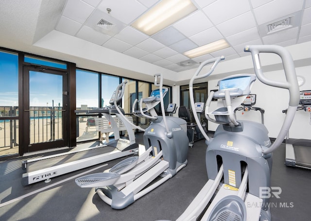 exercise room featuring a drop ceiling