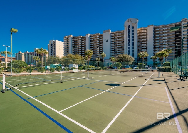 view of tennis court featuring fence and community basketball court