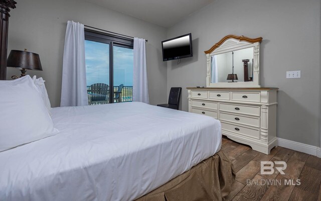 bedroom with wood finished floors, baseboards, and access to exterior