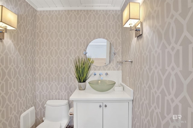 210 S Mobile St Unit 16, Fairhope, AL 36532 - half bath with wallpapered walls, vanity, toilet, and ornamental molding