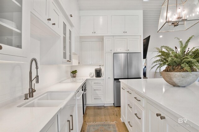 210 S Mobile St Unit 16, Fairhope, AL 36532 - kitchen featuring stainless steel fridge, a sink, light wood-type flooring, and white cabinetry