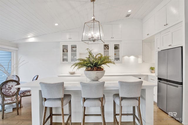 210 S Mobile St Unit 16, Fairhope, AL 36532 - kitchen with freestanding refrigerator, light countertops, white cabinets, light wood finished floors, and recessed lighting