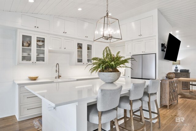210 S Mobile St Unit 16, Fairhope, AL 36532 - kitchen with stainless steel refrigerator, recessed lighting, light countertops, light wood finished floors, and white cabinets