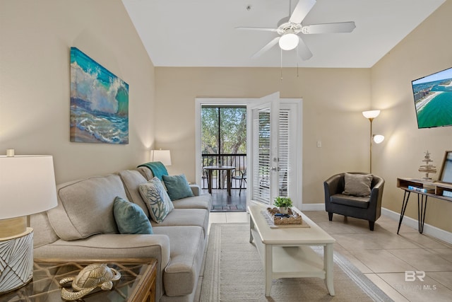 tiled living room with french doors, ceiling fan, and lofted ceiling