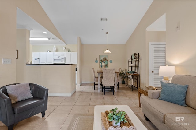 living room with light tile patterned floors, ornamental molding, and lofted ceiling