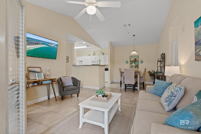 tiled living room with ceiling fan and vaulted ceiling