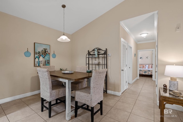 dining space featuring light tile patterned floors and crown molding