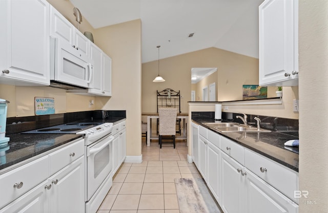 kitchen featuring white appliances, sink, vaulted ceiling, light tile patterned floors, and white cabinetry