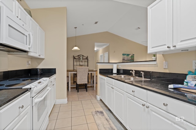 kitchen with white appliances, vaulted ceiling, sink, white cabinetry, and light tile patterned flooring