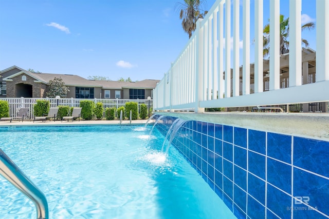 view of swimming pool featuring pool water feature