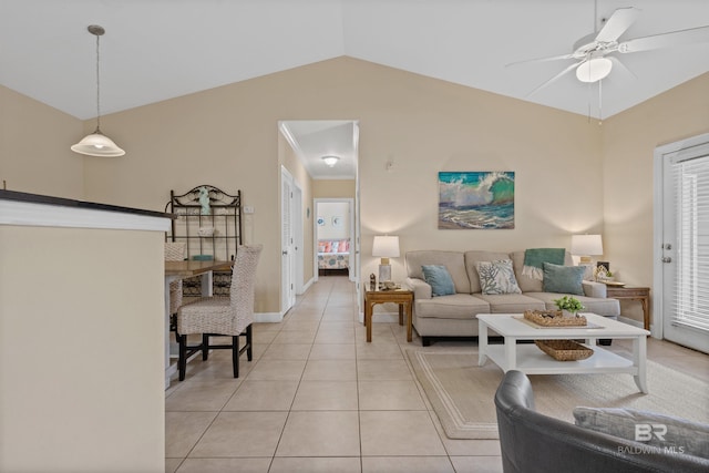 living room featuring ceiling fan, light tile patterned flooring, and vaulted ceiling